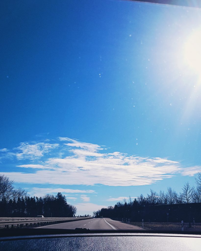Blue skies with long empty road ahead 