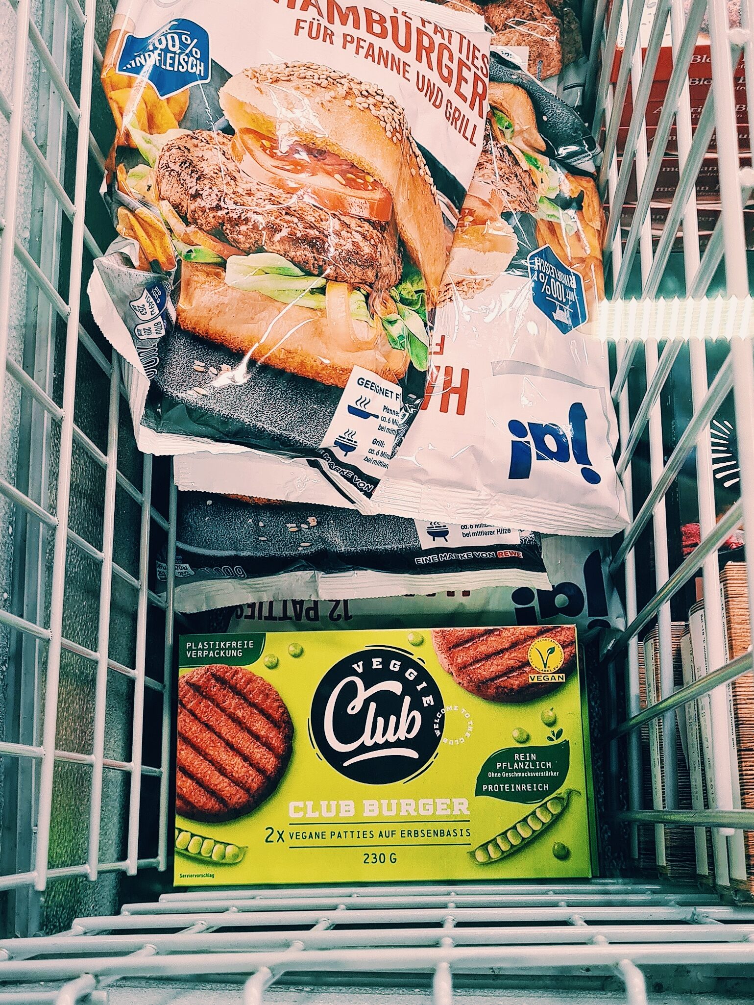 A photo of the meat-free burgers next to meat burgers in the frozen section of a supermarket.